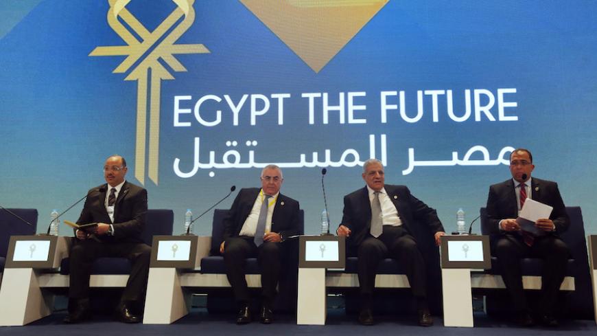 Egypt's Finance Minister Hany Dimian (L-R), central bank governor Hisham Ramez, Prime Minister Ibrahim Mehleb and Planning Minister Ashraf al-Arabi attend the Egypt Economic Development Conference (EEDC) in Sharm el-Sheikh, in the South Sinai governorate, south of Cairo, March 14, 2015. Gulf Arab allies pledged a further $12 billion of investments and central bank deposits for Egypt at an international summit on Friday, a big boost to President Abdel Fattah al-Sisi as he tries to reform the economy after ye