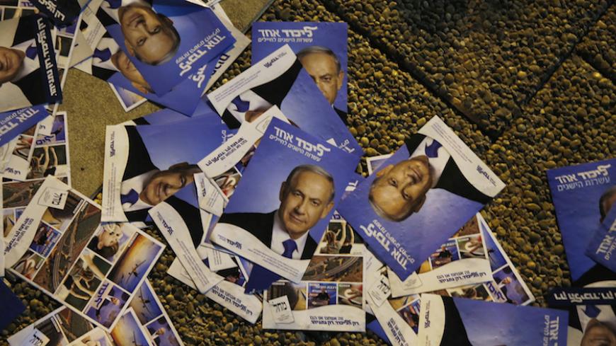 Fliers depicting Israel's Prime Minister Benjamin Netanyahu are seen on the ground during a right-wing rally in Tel Aviv's Rabin Square March 15, 2015. Israel's centre-left opposition is poised for an upset victory in the upcoming parliamentary election, with the last opinion polls before Tuesday's vote giving it a solid lead over Netanyahu's party. REUTERS/Baz Ratner (ISRAEL - Tags: POLITICS ELECTIONS) - RTR4TGF7