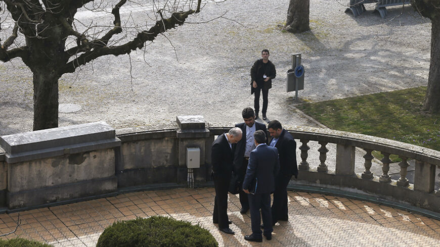 Iran's nuclear chief Ali Akbar Salehi (bottom L) and other Iranian negotiators talk outside the Beau-Rivage hotel, following a meeting between U.S. Secretary of State John Kerry and Iran's Foreign Minister Javad Zarif over Iran's nuclear program, in Lausanne, March 16, 2015.     REUTERS/Brian Snyder   (SWITZERLAND - Tags: POLITICS) - RTR4TJ9L