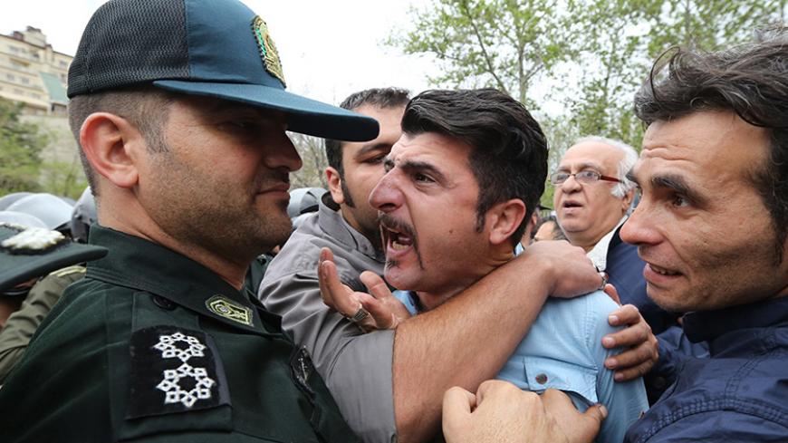 Iranians scuffle with security forces during a demonstration outside the Saudi embassy in Tehran on April 11, 2015, to protest against alleged sexual harassment against Iranian youths by Saudi police. Media reported that two Iranian teenagers who had gone on pilgrimage to holy sites in Saudi Arabia had been sexually harassed by police at the Red Sea airport of Jeddah, as they prepared to return home. AFP PHOTO / ATTA KENARE        (Photo credit should read ATTA KENARE/AFP/Getty Images)