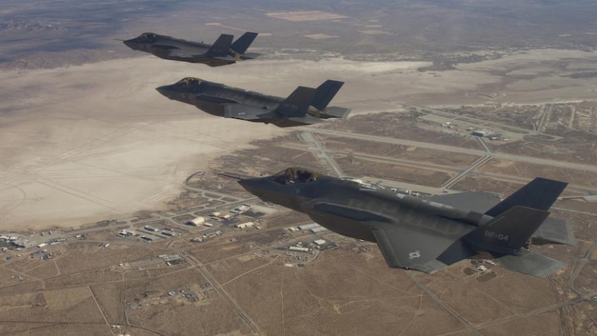 Three F-35 Joint Strike Fighters (rear to front) AF-2, AF-3 and AF-4, can be seen flying over Edwards Air Force Base in this December 10, 2011 handout photo provided by Lockheed Martin. Lockheed Martin Corp on February 25, 2013 said there was no evidence that a lithium-ion battery contributed to a Feb. 14 incident that caused smoke in the cockpit of an F-35 test plane. Lockheed spokesman Michael Rein said initial reviews indicated a potential failure in the plane's cooling system, which had been removed fro