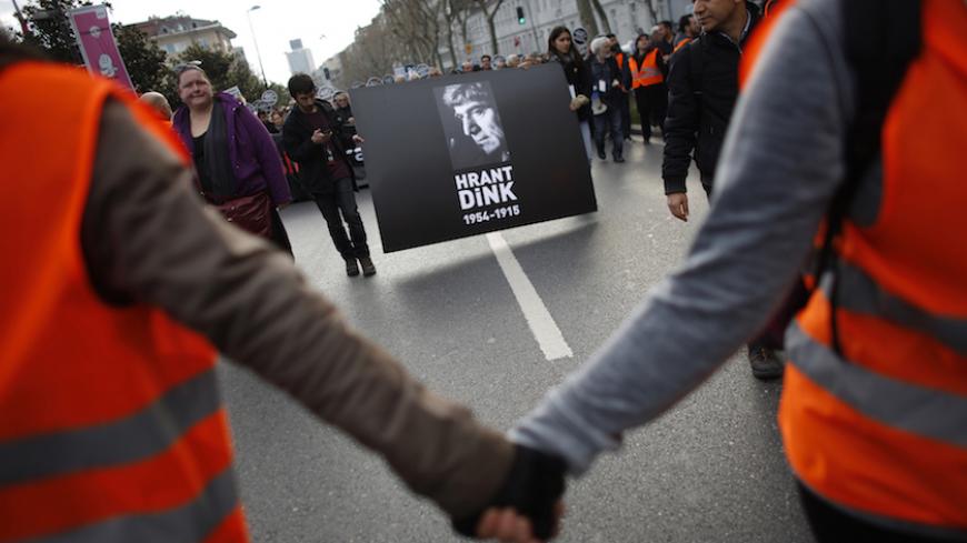 Protesters march during a demonstration to mark the eighth anniversary of the killing of Turkish-Armenian editor Hrant Dink as they carry his portrait in Istanbul January 19, 2015. Editor of the bilingual Turkish-Armenian weekly Agos and Turkey's best known Armenian voice abroad, Dink was shot in broad daylight in a busy Istanbul street as he left his office. Dink had angered Turkish nationalists with articles on Armenian identity and references to a Turkish "genocide" of Christian Armenians in 1915 - which