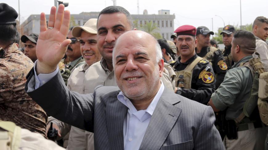 Iraq's Prime Minister Haidar al-Abadi tours the city of Tikrit after Iraq security forces regained control from Islamist State militants, April 1, 2015. Iraqi troops and Shi'ite paramilitary fighters were battling Islamic State on Wednesday in northern Tikrit, which officials described as the Sunni Muslim militant group's last stronghold in the city. REUTERS/Stringer - RTR4VSL0