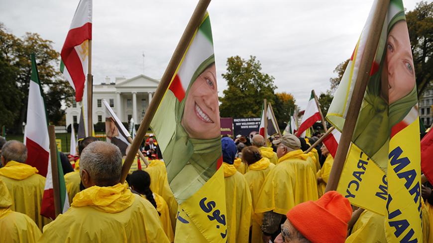 Supporters of Iranian opposition group Mujahedin-e Khalq (MEK) hold flags showing Maryam Rajavi, head of the National Council of Resistance of Iran (NCRI), as they rally against Iraq's Prime Minister Nuri al-Maliki hours before he is scheduled to meet with U.S. President Barack Obama, at the White House in Washington, November 1, 2013. The MEK fought on the side of former Iraqi leader Saddam Hussein during the 1980-88 Iran-Iraq war, mounting attacks on Iran from Iraq, and are calling for the U.S. to hold Ir