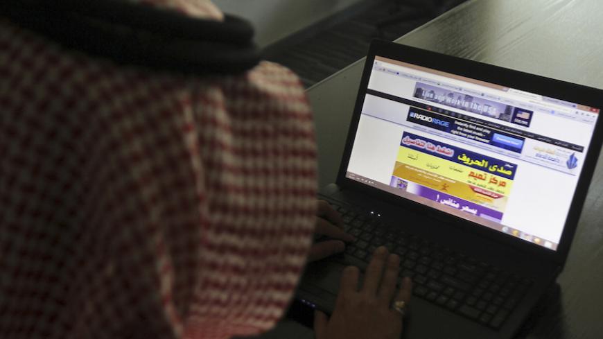 A Saudi man explores a website on his laptop in Riyadh February 11, 2014. Syria's civil war has led to a new, greater threat of Islamist radicalism in Saudi Arabia that requires a more aggressive "war of ideology" on the Internet, says the man responsible for online monitoring in the kingdom. Remarks by the head of the Saudi Ideological Security Directorate (ISD) suggest that the unit, known for keeping tabs on liberal activists and women drivers as well as Islamist extremists, is turning its focus increasi