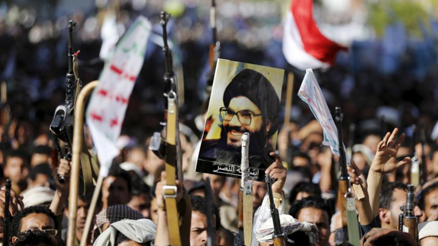A follower of the Houthi group holds up a poster of Lebanon's Hezbollah leader Sayyed Hassan Nasrallah during a demonstration against the Saudi-led air strikes in Sanaa April 22, 2015. REUTERS/Khaled Abdullah - RTX19UHF