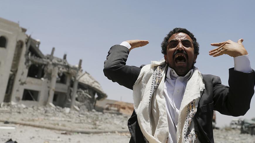 A Houthi militant reacts at the yard of the residence of the military commander of the Houthi militant group, Abdullah Yahya al Hakim, after an air strike destroyed it, in Sanaa April 28, 2015. Saudi-led aircraft pounded Iran-allied Houthi militiamen and rebel army units on Monday, dashing hopes for a pause in fighting to let aid in as relief officials warned of a catastrophic humanitarian crisis. REUTERS/Khaled Abdullah - RTX1AM8S