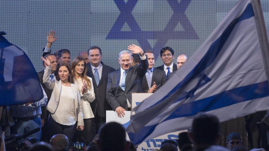 Israeli Prime Minister and leader of the ruling rightwing Likud party, Benjamin Netanyahu (C) and party's members gather on stage during a campaign meeting ahead of the early elections for the 20th Knesset on January 5, 2014 in the coastal Israeli city of Tel Aviv. The general elections, to be held on March 17, 2015 had been due in late 2017, but Netanyahu brought the polls forward after the collapse of his fractious coalition in early December. Primary elections of Likud party took place on December 31 ahe