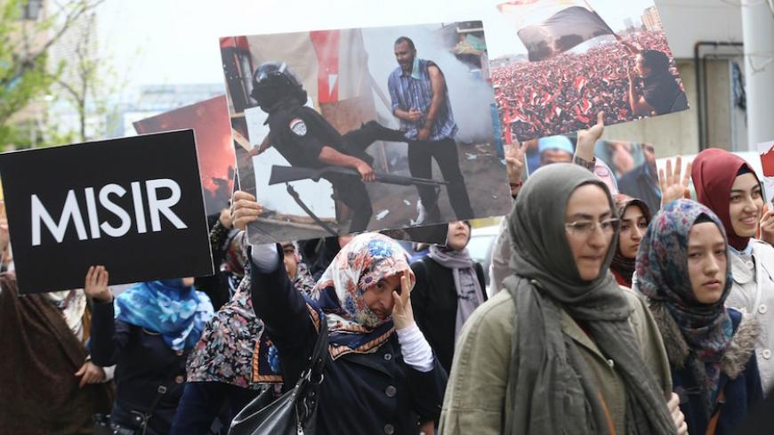 Supporters of the Egyptian Muslim Brotherhood take part in a rally to protest against the death penalties for the members of the radical group in Egypt, near the Egyptian embassy in Ankara on April 18, 2014. AFP PHOTO / ADEM ALTAN        (Photo credit should read ADEM ALTAN/AFP/Getty Images)