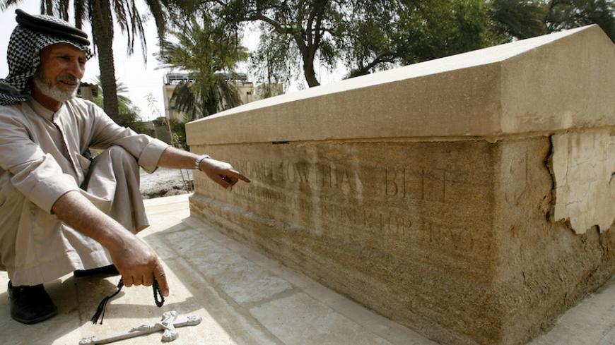 Iraqi gravekeeper Ali Mansur points to the tomb of Gertrude Bell in Iraq April 30, 2006. Bell, an "oriental secretary" to British governments, was credited with drawing the boundaries of modern Iraq out of the ruins of the Ottoman Empire at the end of World War One. Bell, also a British traveller, writer and linguist, was one of the most powerful women of the 1920s, an adviser to empire builders and confidante to kings.  She died in Baghdad in 1926 and rests in a forgotten cemetery in the capital. Picture t