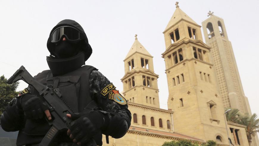 A special forces police officer stands guard to secure the area around Saint Mark's Coptic Orthodox Cathedral before a Coptic Christmas mass in Cairo January 6, 2015. Egypt's Coptic Christmas falls on Wednesday and security is typically tightened at churches ahead of the holiday after a string of attacks on Christian targets over the past years. REUTERS/Mohamed Abd El Ghany (EGYPT - Tags: RELIGION MILITARY CIVIL UNREST) - RTR4K8RY