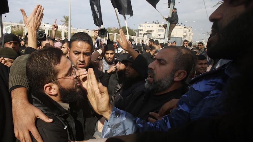 Palestinian police officers loyal to Hamas push back Salafists during a protest against satirical French weekly magazine Charlie Hebdo's cartoons of the Prophet Mohammad, outside the French Cultural Centre in Gaza city January 19, 2015. Dozens of Jihadist Salafi men rallied in Gaza on Monday to condemn continued publication by French satirical magazine Charlie Hebdo of cartoons deemed offensive to Islam's Prophet. Charlie Hebdo published a picture of Mohammad weeping on its cover last week after gunmen stor