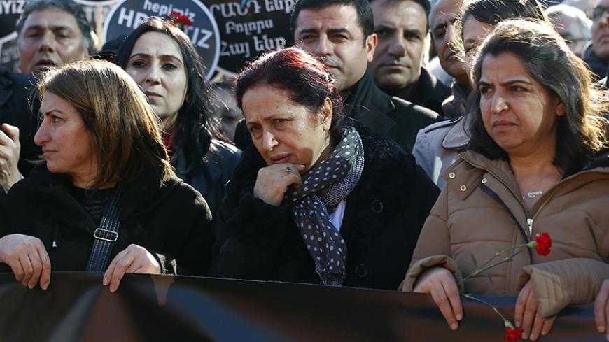 Rakel Dink (C), widow of slain Turkish-Armenian editor Hrant Dink, walks toward the Agos newspaper office during a demonstration to mark the eighth anniversary of his death, in Istanbul January 19, 2015.  Editor of the bilingual Turkish-Armenian weekly Agos and Turkey's best known Armenian voice abroad, Dink was shot in broad daylight in a busy Istanbul street as he left his office. Dink had angered Turkish nationalists with articles on Armenian identity and references to a Turkish "genocide" of Christian A