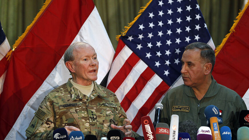 U.S. Army General Martin Dempsey (L) speaks during news conference with Iraq's Defence Minister Khaled al-Obeidi in Baghdad March 9, 2015.  REUTERS/Ahmed Saad (IRAQ - Tags: POLITICS CIVIL UNREST CONFLICT) - RTR4SM9Z