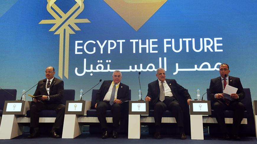 Egypt's Finance Minister Hany Dimian (L-R), central bank governor Hisham Ramez, Prime Minister Ibrahim Mehleb and Planning Minister Ashraf al-Arabi attend the Egypt Economic Development Conference (EEDC) in Sharm el-Sheikh, in the South Sinai governorate, south of Cairo, March 14, 2015. Gulf Arab allies pledged a further $12 billion of investments and central bank deposits for Egypt at an international summit on Friday, a big boost to President Abdel Fattah al-Sisi as he tries to reform the economy after ye