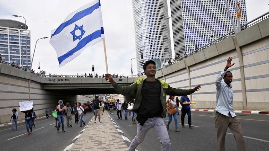 Protesters, mainly who are Israeli Jews of Ethiopian origin, run at a main road in Tel Aviv as they block it during a demonstration against what they say is police racism and brutality, after the emergence last week of a video clip that showed policemen shoving and punching a black soldier May 3, 2015. Israeli mounted police charged hundreds of ethnic Ethiopian citizens and fired stun grenades on Saturday to try to clear one of the most violent protests in memory in the heart of Tel Aviv. Picture taken May 