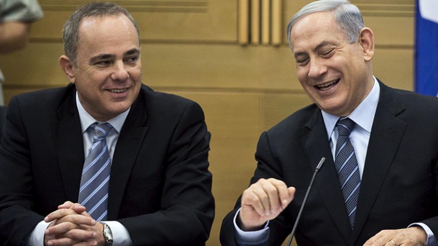 Israel's Prime Minister Benjamin Netanyahu (R) and Strategic Affairs Minister Yuval Steinitz attend a Likud party meeting at parliament in Jerusalem May 11, 2015. REUTERS/Ronen Zvulun  - RTX1CG4C