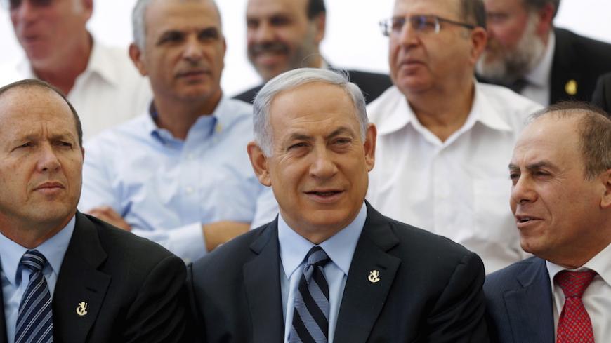 Israeli Prime Minister Benjamin Netanyahu (C) poses with his new government and the Mayor of Jerusalem Nir Barkat (L) as he holds a meeting of his new cabinet, in honour of Jerusalem Day, at the Israeli Museum in Jerusalem May 19,  2015. REUTERS/Atef Safadi/Pool - RTX1DLKY