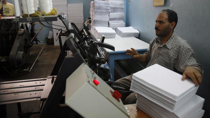 A blind Egyptian man works in a print machine printing books using Braille system at the Model Center for the care of the Blind in Cairo, May 15, 2008. May 17 is the United Nation's World Telecommunication and Information Society Day focusing this year on connecting persons with disabilities.  REUTERS/Asmaa Waguih  (EGYPT) - RTX5QX8