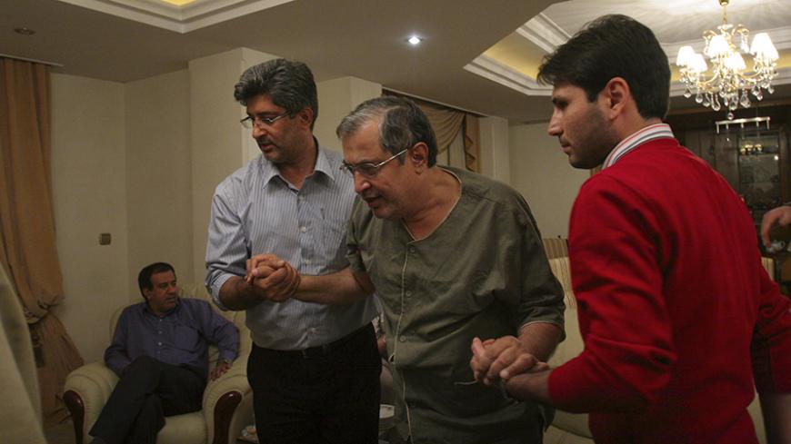 EDITORS' NOTE: Reuters and other foreign media are subject to Iranian restrictions on their ability to film or take pictures in Tehran.

Leading Iranian reformist Saeed Hajjarian is helped to a seat in his home after he was released from prison in Tehran September 30, 2009. Iran freed the senior reformer, accused of fomenting opposition protests after a disputed presidential election in June, on bail on Wednesday after more than three months in detention.  REUTERS/Yalda Moaiery/ISNA  (IRAN POLITICS) FOR EDI