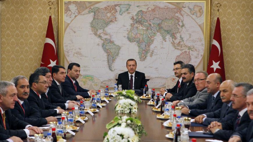 Turkey's Prime Minister Tayyip Erdogan meets with lawmakers from Azerbaijan (left row) as he is flanked by his officials (right row) in Ankara October 14, 2009. An agreement signed by Turkey and Armenia on Saturday, which would reopen the border and restore ties poisoned by a century of hostility, could help stabilise the south Caucasus with its vulnerable energy corridor and ease Armenia's geographical isolation. Both parliaments must approve it. But it is resisted by nationalists in both countries as well