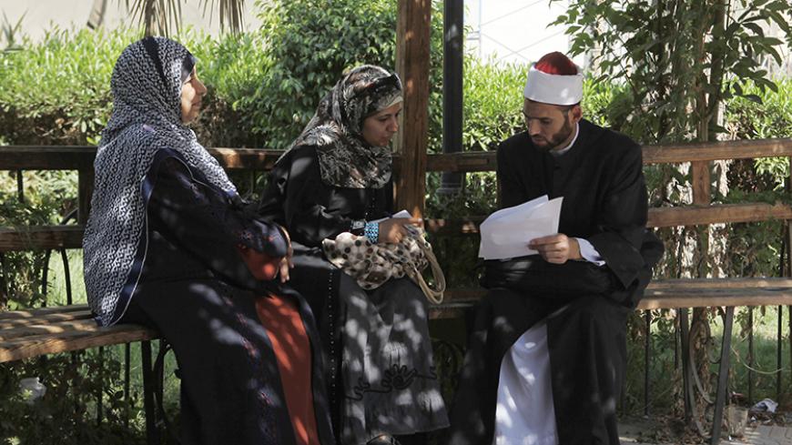 An Al-Azhar Sheikh, explains some papers in the courtyard of Al-Azhar adminstrative building, in Cairo September 10, 2012. A proposal by ultraconservative Salafis to give Egypt's main Islamic institution the final say on whether the law of the land adheres to Islamic law threatens to bring the already painfully slow process of drafting the new constitution to a grinding halt. The proposal would give the revered Al-Azhar power similar to a supreme court by making it the arbiter of whether a law conforms with
