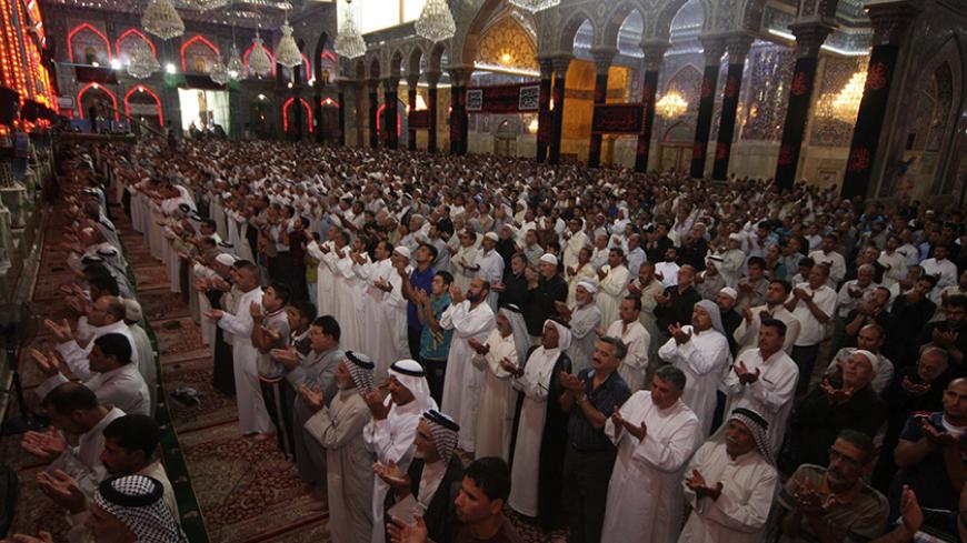 Shi'ite Muslims attend Friday prayers at the Imam Hussein shrine in the holy city of Kerbala July 18, 2014. Iraq's top Shi'ite Muslim cleric criticised the government and international agencies on Friday for failing to do enough to help hundreds of thousands of civilians displaced by fighting between government forces and Sunni Islamist insurgents. REUTERS/Mushtaq Muhammed (IRAQ - Tags: CIVIL UNREST POLITICS RELIGION) - RTR3Z7IR