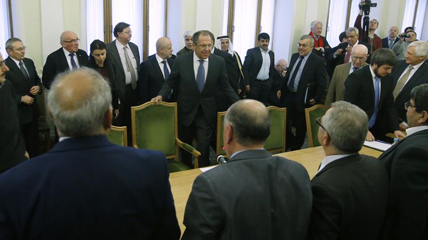 Russia's Foreign Minister Sergei Lavrov (C) attends a meeting with members of the Syrian opposition and the Damascus government ahead of talks that attempt to revive peace plan efforts in Syria, in Moscow, January 28, 2015.  Russian Foreign Minister Sergei Lavrov urged members of the Syrian opposition and representatives from Damascus at peace talks in Moscow on Wednesday to join forces to combat the threat of "terrorism". Expectations of a breakthrough in Moscow are low, but Russia hopes the talks will giv