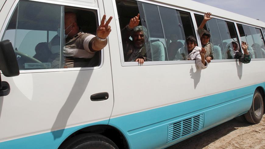 Members of the Yazidi minority sect who were newly released are seen in a vehicle on the outskirts of Kirkuk April 8, 2015. More than 200 elderly and infirm Yazidis were freed on Wednesday by Islamic State militants who had been holding them captive since overruning their villages in northwestern Iraq last summer. REUTERS/Ako Rasheed - RTR4WJPO