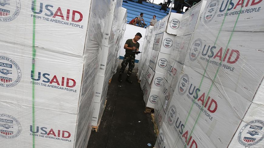 A Philippine army soldier counts boxes containing tent material from U.S. relief organisation USAID, as he prepares the load to be deployed by airlift by the U.S. Air Force to victims of super typhoon Haiyan, at a Manila airport November 13, 2013. Philippine officials have been overwhelmed by Haiyan, one of the strongest typhoons on record, which tore through the central Philippines on Friday and flattened Tacloban, coastal capital of Leyte province where officials had feared 10,000 people died, many drowni