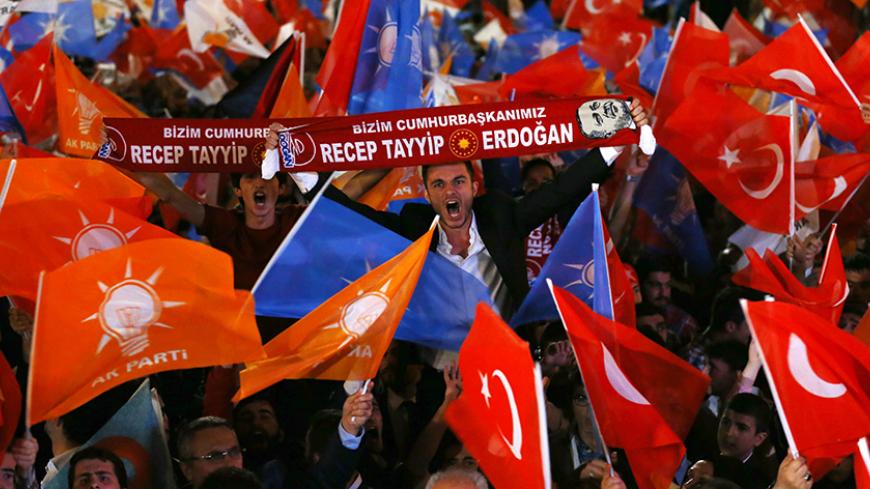 Supporters wave Turkish national and party flags outside the AK Party headquarters in Ankara, Turkey, June 7, 2015. Turkish President Tayyip Erdogan's hopes of assuming greater powers suffered a serious blow on Sunday when the ruling AK Party failed to win an outright majority in a parliamentary election, partial results showed. With 94 percent of ballots counted, the AKP had taken 41 percent of the vote, according to broadcaster CNN Turk, a result which will leave it struggling to form a stable government 