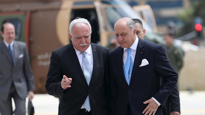 France's Foreign Minister Laurent Fabius (R) is welcomed by Palestinian Foreign Minister Riyad al-Maliki upon Fabius' arrival at the West Bank city of Ramallah June 21, 2015. Prime Minister Benjamin Netanyahu prefaced talks about a French-led peace initiative on Sunday by saying foreign powers were trying to dictate to Israel a deal with the Palestinians. Fabius, on a two-day visit to the Middle East, was due to meet Palestinian leaders in the occupied West Bank before seeing Netanyahu later in the day. REU