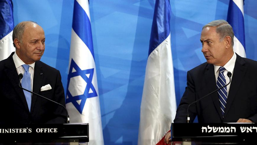 Israel's Prime Minister Benjamin Netanyahu (R) and France's Foreign Minister Laurent Fabius deliver statements in Jerusalem June 21, 2015. Netanyahu prefaced talks about a French-led peace initiative on Sunday by saying foreign powers were trying to dictate to Israel a deal with the Palestinians. Fabius is promoting a French-led initiative that would see the Israeli-Palestinian peace process, which collapsed in 2014, relaunched through an international support group comprising Arab states, the European Unio