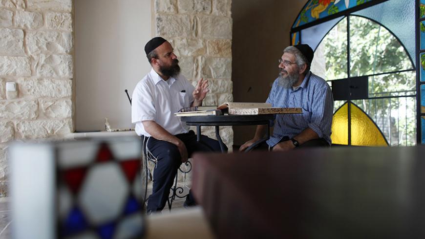 Eyal Riess (L) from the International Center for Tzfat Kabbalah and artist Michael Chouraqui study religious texts together in the northern town of Safed May 26, 2010. Safed -- also known as Tzfat -- is where the tourism boom Israel is enjoying with a lull in violence comes with a spiritual twist, thanks in part to the interest the Queen of Pop takes in Jewish Kabbalah mysticism, which has roots in the town. To match Reuters Life! TOURISM-ISRAEL/KABBALAH. 
REUTERS/Nir Elias (ISRAEL - Tags: TRAVEL SOCIETY RE