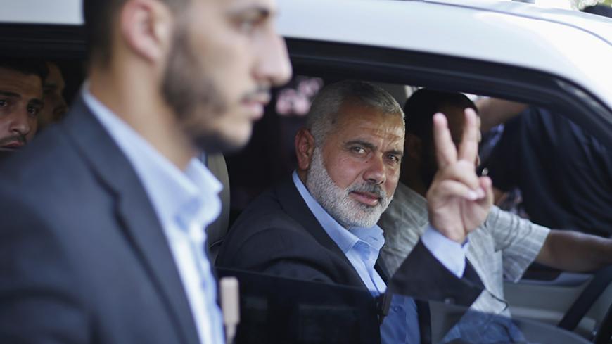 Senior Hamas leader Ismail Haniyeh gestures as leaves his office as a former Hamas government Prime Minister, in Gaza City June 2, 2014. President Mahmoud Abbas swore in a Palestinian unity government on Monday under a reconciliation deal with Hamas Islamists that led Israel to freeze U.S.-brokered peace talks with the Western-backed leader. REUTERS/Suhaib Salem  (GAZA - Tags: POLITICS) - RTR3RTYV