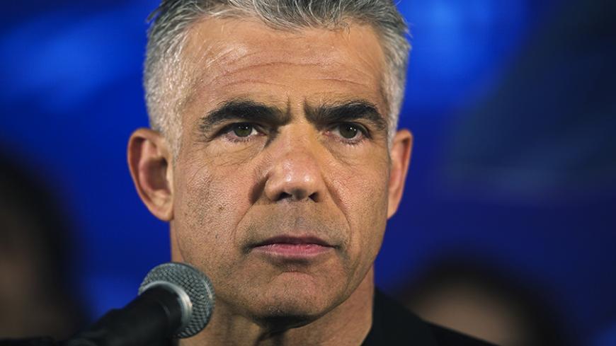 Yair Lapid, head of Yesh Atid party, speaks to supporters during a conference in Holon near Tel Aviv March 12, 2015. Israelis will vote in a parliamentary election on March 17, choosing among party lists of candidates to serve in the 120-seat Knesset. REUTERS/Amir Cohen (ISRAEL - Tags: ELECTIONS POLITICS) - RTR4T55G