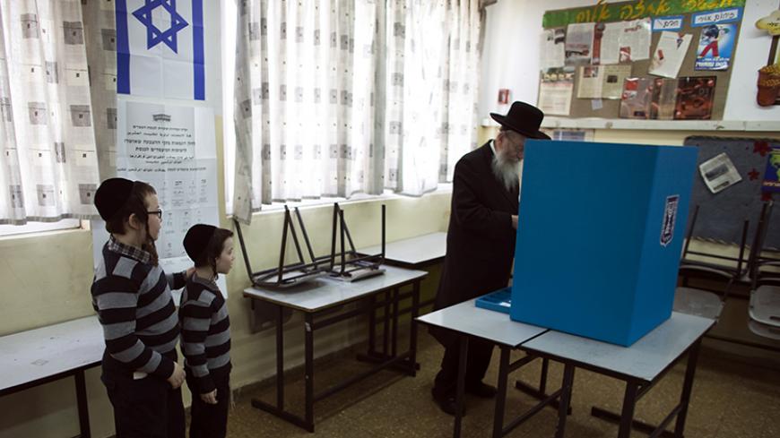 Israeli parliament member Yaakov Litzman stands at a voting booth as he casts his ballot at a polling station in Jerusalem March 17, 2015. Millions of Israelis voted on Tuesday in a tightly fought election, with Prime Minister Benjamin Netanyahu facing an uphill battle to defeat a strong campaign by the centre-left opposition to deny him a fourth term in office. REUTERS/Ronen Zvulun (JERUSALEM - Tags: POLITICS ELECTIONS) - RTR4TNNN