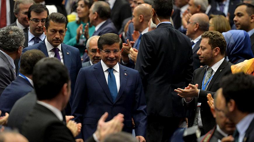 Turkish Prime Minister Ahmet Davutoglu arrives at a meeting with his AK Party local officials at the party headquarters in Ankara, Turkey, June 11, 2015. Davutoglu said on Thursday history had shown that coalition governments were not suitable for Turkey but that his ruling AK Party was open to all options. "We've used the coalition eras of the 1970s and 1990s as an example to show that coalitions are not suitable for Turkey and we still stand by that stance," Davutoglu told a meeting of AKP local officials