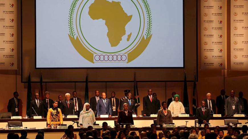 Leaders of the AU stand during the opening of the 25th African Union summit in Johannesburg June 14, 2015. A South African court issued an interim order on Sunday preventing Sudanese President Omar al-Bashir leaving the country, where he was attending an African Union summit, until the judge hears an application calling for his arrest. Bashir is accused in an International Criminal Court arrest warrant of war crimes and crimes against humanity over atrocities in the Darfur conflict. REUTERS/Siphiwe Sibeko  