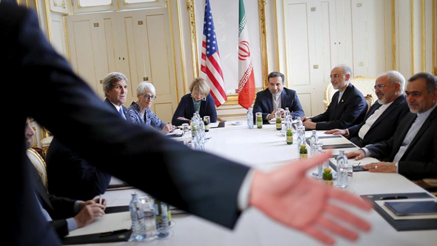 A security personnel asks reporters to leave a room where U.S. Secretary of State John Kerry (L) is meeting with Iranian Foreign Minister Mohammad Javad Zarif (2nd R) at a hotel in Vienna, Austria July 1, 2015. International Atomic Energy Agency (IAEA) chief Yukiya Amano will be in Tehran on Thursday to discuss monitoring sensitive nuclear sites with senior officials as major powers and Iran seek a breakthrough in forging a lasting nuclear agreement. Iran and world powers gave themselves an extra week on Tu