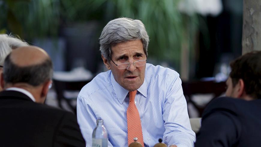 U.S. Secretary of State John Kerry (C), Under Secretary of State for Political Affairs Wendy Sherman, National Security Council point person on the Middle East Robert Malley (front L) and Chief of Staff Jon Finer (R) meet on the terrace of a hotel where the Iran nuclear talks meetings are being held in Vienna, Austria July 2, 2015. Iran's stockpile of low-enriched uranium gas dropped below the maximum level required under a 2013 interim nuclear agreement with world powers, a U.N. report showed, but a U.S. t