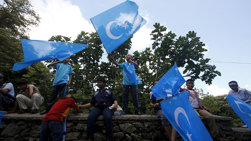 Boys wave East Turkestan flags during a protest against China near the Chinese Consulate in Istanbul, Turkey, July 5, 2015. China warned its citizens travelling in Turkey to be careful of anti-Beijing protests, warning them that some Chinese tourists have recently been "attacked and disturbed". The notice, posted on the Ministry of Foreign Affairs website on Sunday, said that there have recently been "multiple" demonstrations in Turkey targeting the Chinese government. The notice gave no details regarding t