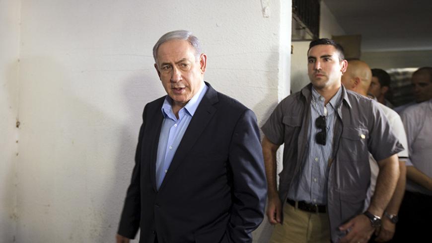 Israeli Prime Minister Benjamin Netanyahu (L) delivers a statement to the media after visiting the family of Avraham Mengisto, outside their home in the southern city of Ashkelon, Israel July 10, 2015. Two Israeli citizens, one of them Mengisto, are being held by Hamas Netanyahu said on Thursday, a situation that could lead to demands for a prisoner exchange between Israel and the Islamist militant group. Hamas, which took control of the Palestinian coastal enclave in 2007 and fought three wars with Israel 