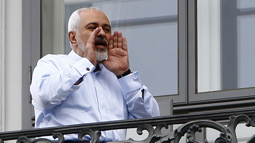 Iranian Foreign Minister Javad Zarif talks to journalists as he stands on the balcony of Palais Coburg, the venue for nuclear talks, Austria, July 13, 2015. Iran and six world powers appeared close to a deal on Monday to give Tehran sanctions relief in exchange for limits on its nuclear programme, but Iranian officials said talks could run past their latest midnight deadline and success was not guaranteed.  REUTERS/Leonhard Foeger - RTX1K8T6
