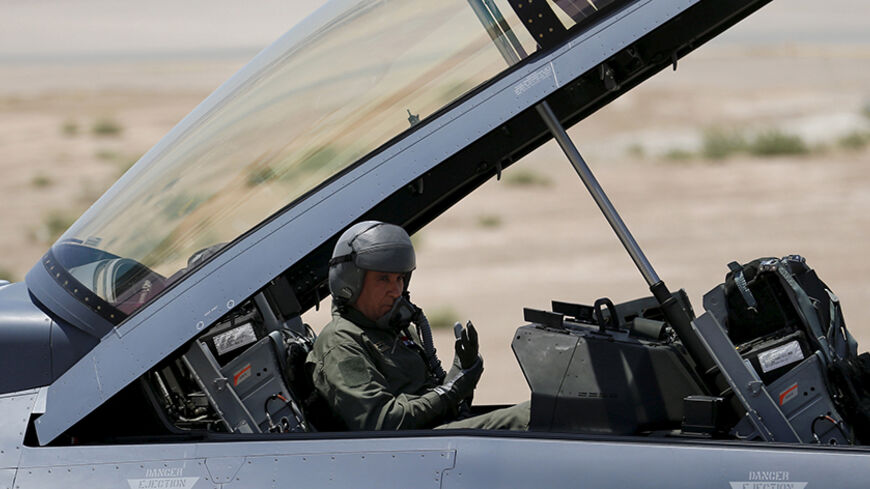 Iraq's Defence Minister Khaled al-Obeidi sits in a F-16 fighter jet, during an official ceremony to receive four of these aircrafts from the U.S., at a military base in Balad, Iraq, July 20, 2015. REUTERS/Thaier Al-Sudani - RTX1L2B3