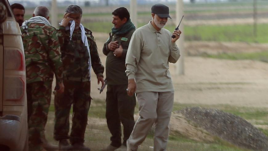 Iranian Revolutionary Guard Commander Qassem Soleimani uses a walkie-talkie at the frontline during offensive operations against Islamic State militants in the town of Tal Ksaiba in Salahuddin province March 8, 2015. Picture taken March 8, 2015.   REUTERS/Stringer (IRAQ - Tags: CIVIL UNREST CONFLICT POLITICS) - RTR4TU0N