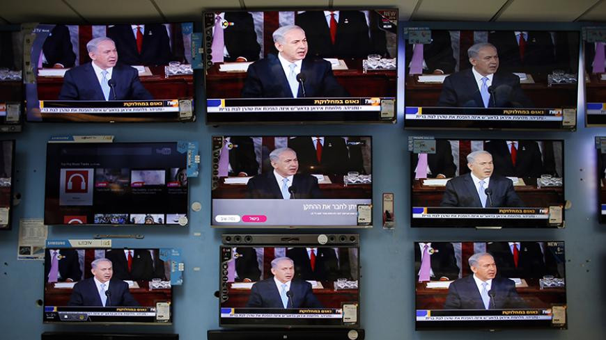 Israel's Prime Minister Benjamin Netanyahu is seen delivering his speech to the U.S. Congress on television screens in an electronics store in a Jerusalem shopping mall March 3, 2015. Netanyahu warned U.S. President Barack Obama on Tuesday against accepting a nuclear deal with Iran that would be a "countdown to a potential nuclear nightmare" by a country that "will always be an enemy of America". REUTERS/Ronen Zvulun (JERUSALEM - Tags: POLITICS) - RTR4RWX2
