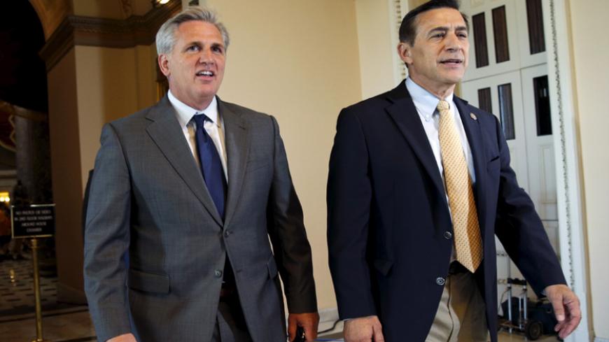 House Majority Leader Kevin McCarthy (R-CA), L, and Rep. Darrell Issa (R-CA) walk to the House Chamber where members of congress were voting on a package of trade bills in the U.S. Capitol in Washington June 12, 2015.  REUTERS/Kevin Lamarque  - RTX1G9G9