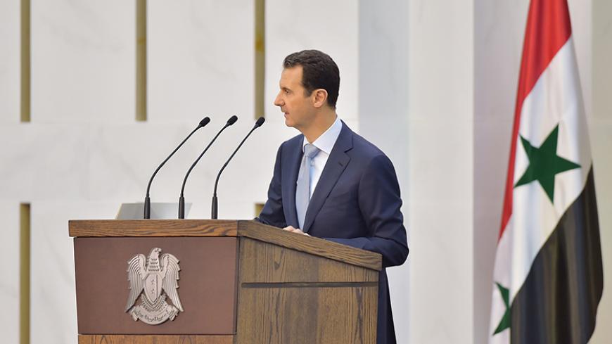 Syria's president Bashar al-Assad speaks during his meeting with the heads and members of public organizations and professional associations in Damascus, Syria, in this handout released by Syria's national news agency SANA on July 26, 2015. Syrian President Bashar al-Assad said on Sunday the army had been forced to give up areas in order to hold onto more important ones in its fight with insurgents, and the scale of the war meant the military faced a manpower shortage. REUTERS/SANA/Handout via Reuters 

ATT