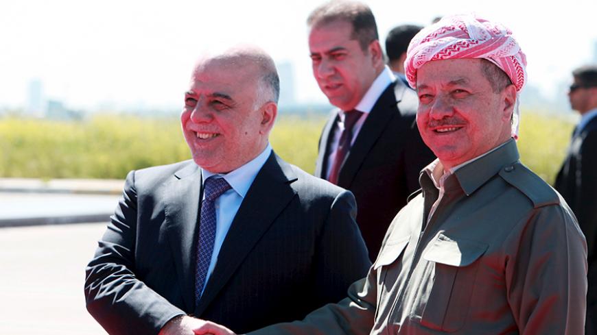 Iraqi Kurdish regional President Massoud Barzani (R) shakes hands with Iraqi Prime Minister Haider al-Abadi at Arbil International Airport April 6, 2015.   REUTERS/Azad Lashkari  - RTR4W82R